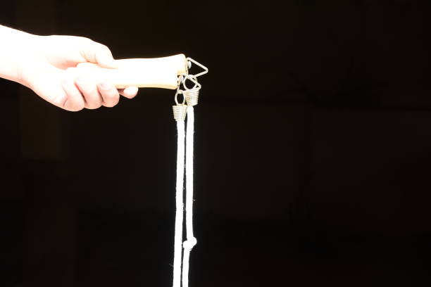 istock A hand holds a jump rope against a black background 920628964