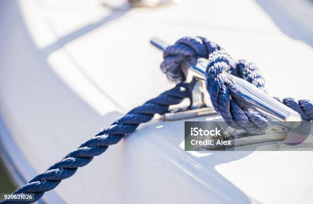 Blue Nautical Rope Is Knotted On Boat Cleat Stock Photo - Download Image Now - Mooring Line, Rope, Tied Knot