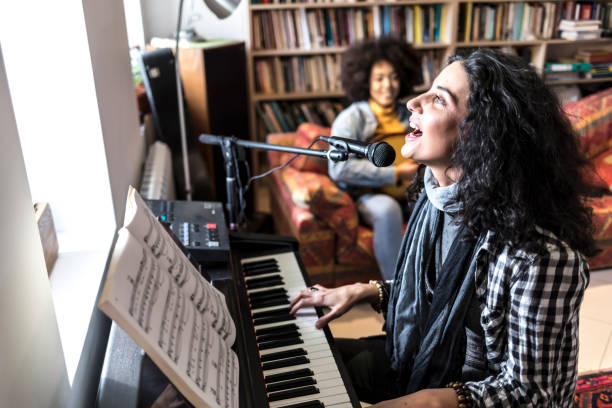 istock Woman singing and playing the piano 920631076