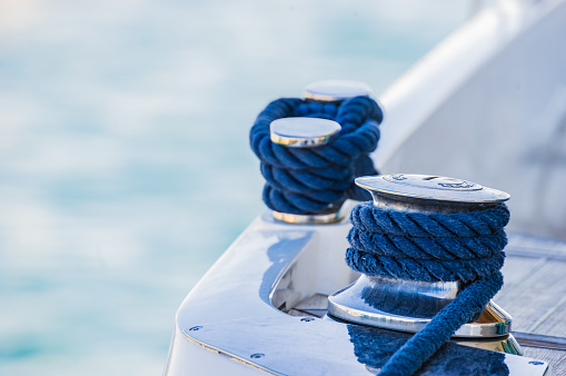 Detail view of motorboat yacht rope cleat on boat deck