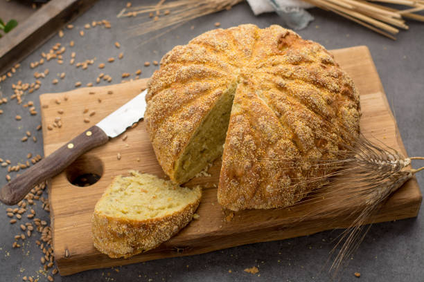 Homemade baked round bread with corn and wheat Homemade baked round bread with organic corn and wheat rustic style bread bun corn bread basket stock pictures, royalty-free photos & images