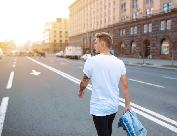 istock Hipster walking in the street. Rear view 920637974