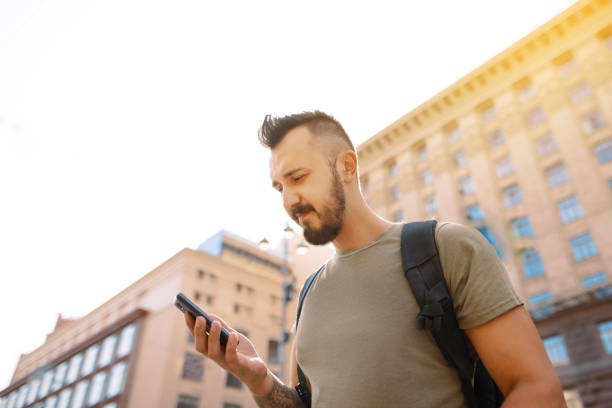 istock Happy hipster man walking street and smiling. 920637980