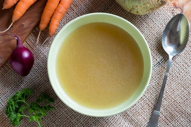 istock Chicken bone broth in a green soup bowl with vegetables 920640628