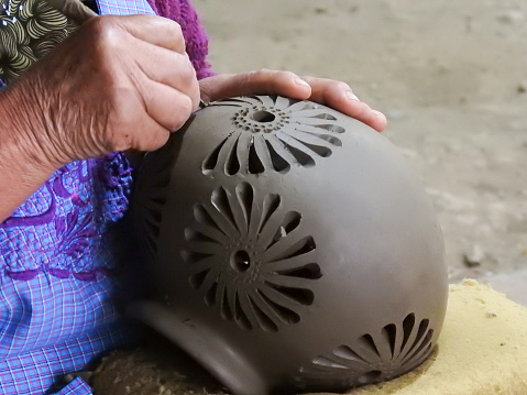 Young woman is making pottery as leisure activity. Earthenware, art and craft concept.