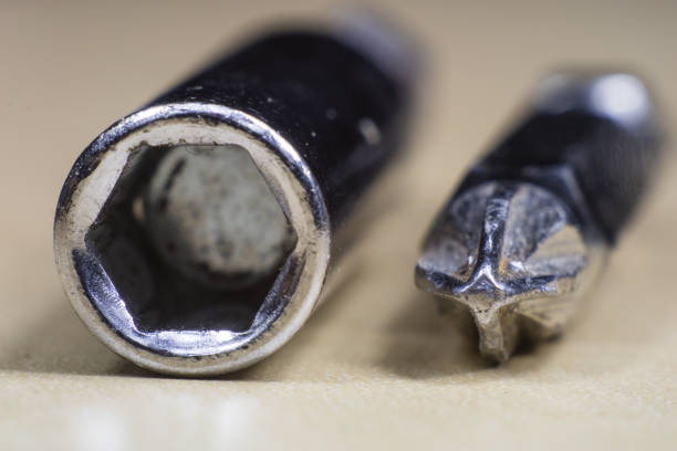 Joinery accessories in a large magnification. The screwdriver bit is shown in macro technology. Black background.