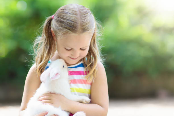 istock Child with rabbit. Easter bunny. Kids and pets. 920651756