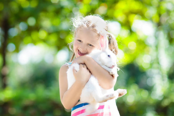 istock Child with rabbit. Easter bunny. Kids and pets. 920653958