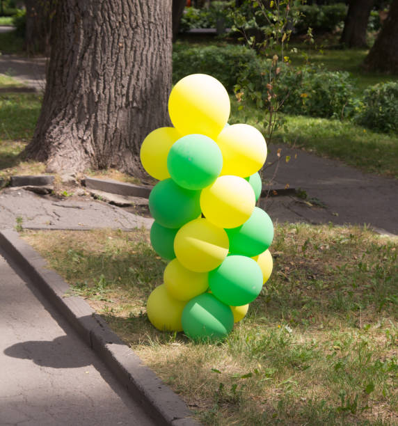 istock yellow and green balloons in nature 920656906
