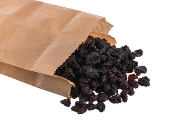 istock Dried black cherries in a packet isolated on white background 920656914