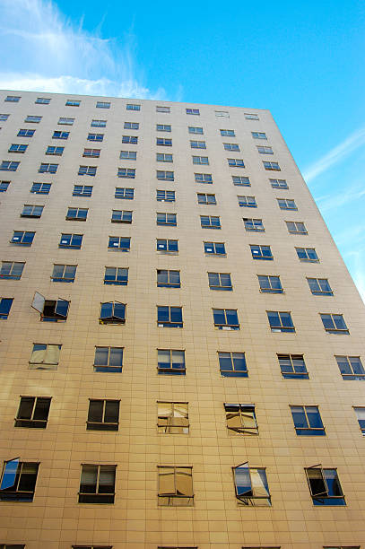 istock downtown building with open/closed windows against a blue sky 92065852