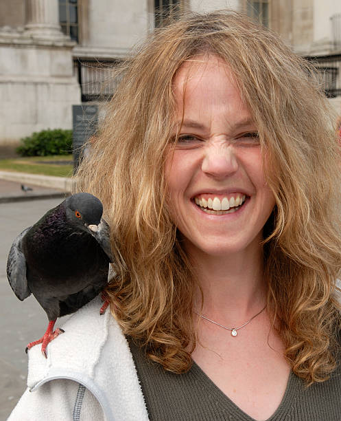 lady with pigeon on shoulder1 stock photo