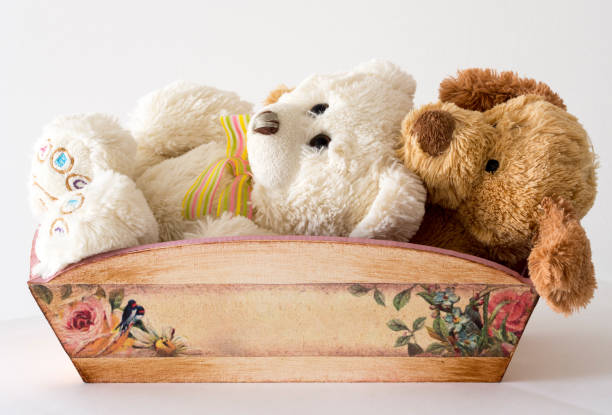 istock plush bear sitting in a wooden basket 920660100