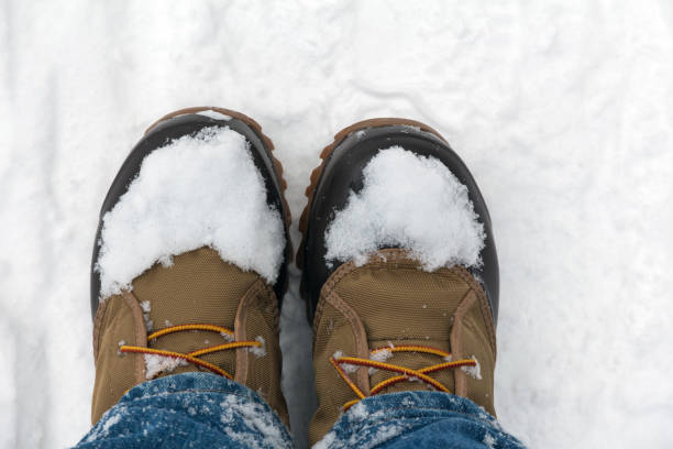 istock legs in blue jeans and winter warm boots in the snow 920666494