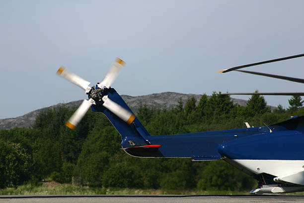 Executive heavy class helicopter shot in flight. Motion blurred rotor blades. Evening twilight cloudy sky.