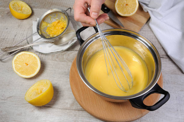 istock Freshly prepared lemon kurd - custard on fruit juice, in a saucepan stir with a spoon 920667178