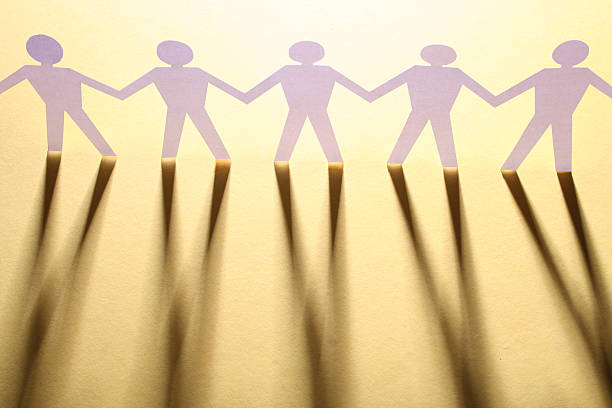 istock figures of man in paper on yellow 92067249