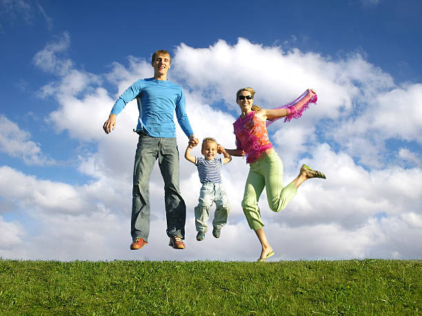 istock fly happy family on blue sky with clouds 92067754