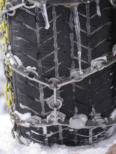 istock Close-up of car tyre fasten with chain 920681242