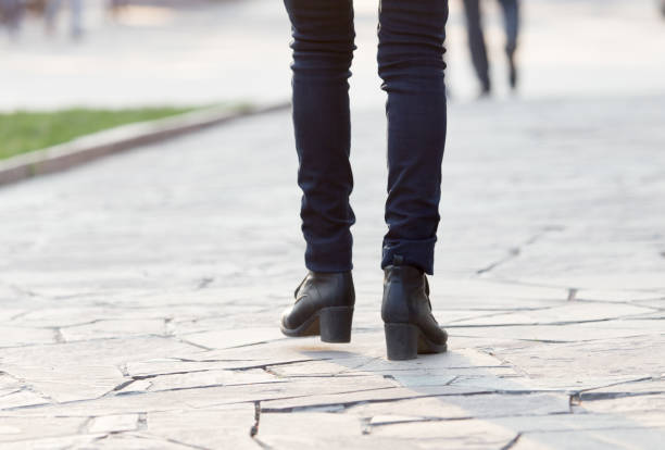 istock Women's feet are on the road 920684058