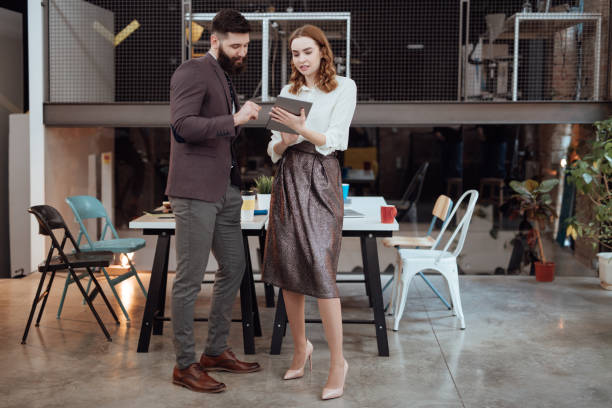 istock Coworkers looking at laptop and preparing for presentation 920695332