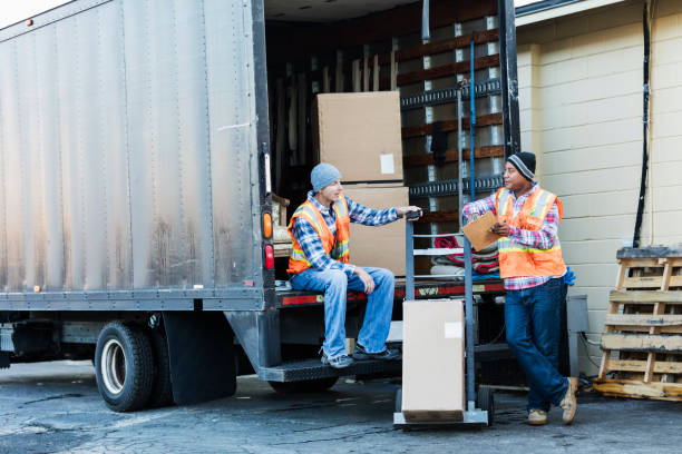 istock Two workers with a truck, moving furniture, boxes 920698896