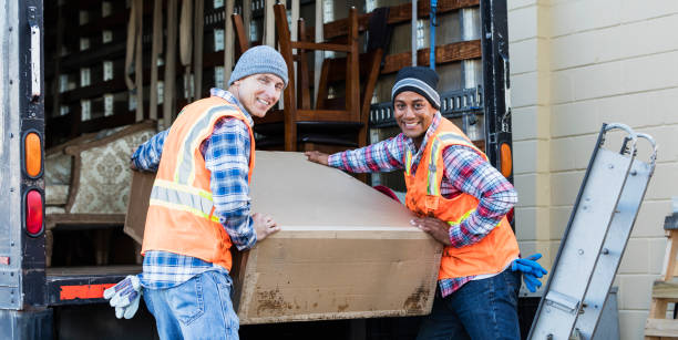 istock Two workers with a truck, moving large box 920699160