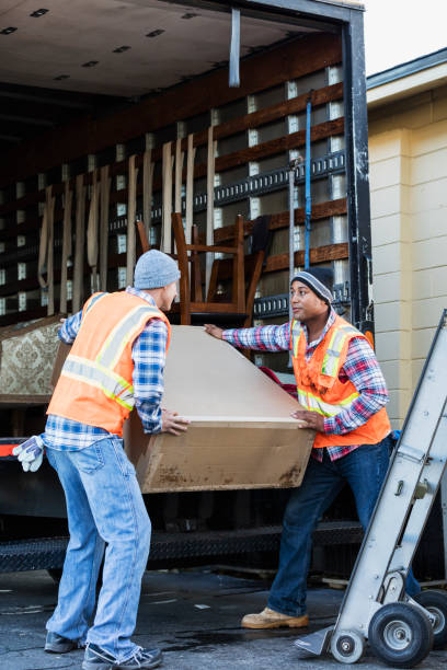 istock Two workers with a truck, moving large box 920699246