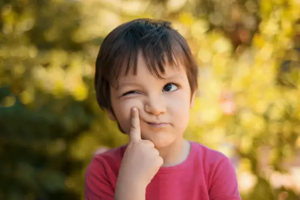 Photo of Close-up portrait of thinking little girl looking away with thoughtful facial expression