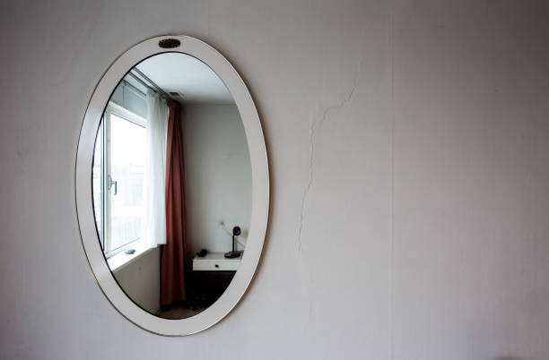 istock Antique old round vintage mirror on  wall with dark shadow 920718036