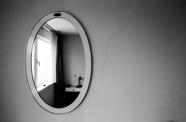 istock Old round vintage antique mirror on dark wall black and white 920718142