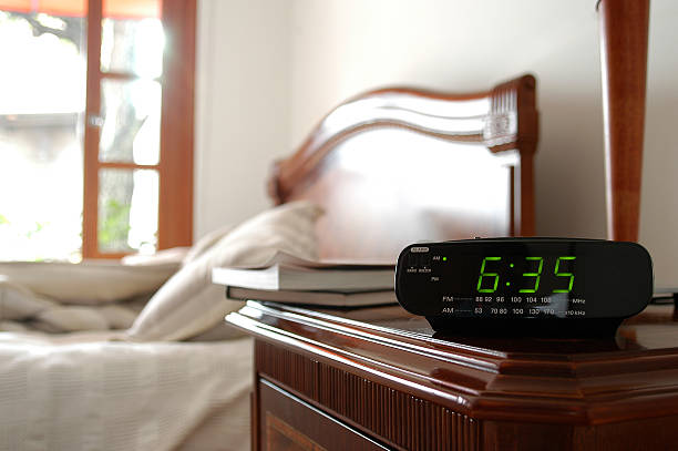 istock An alarm clock with time of 635 over a blurred bed 92072319