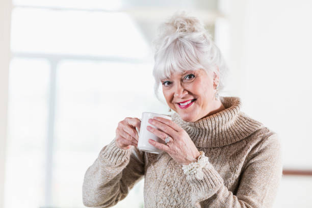 istock Senior woman laughing, drinking coffee 920723454