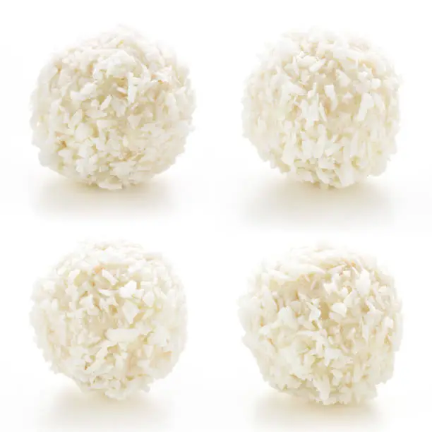 Homemade candy white chocolate and coconut on a plate on white isolated background. Set Candy  truffles snowball. Selective focus