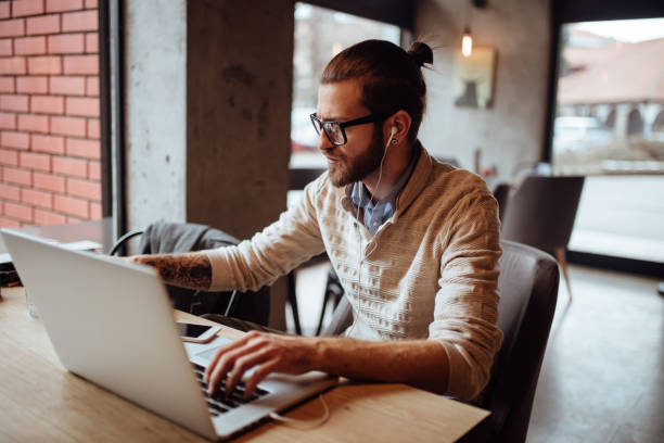 istock Bearded man working on his laptop in a cafe 920728042