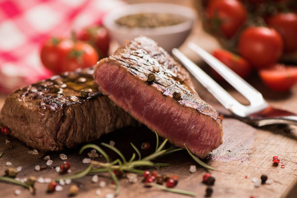 istock Delicious beef steak on wooden table, close-up 920729322