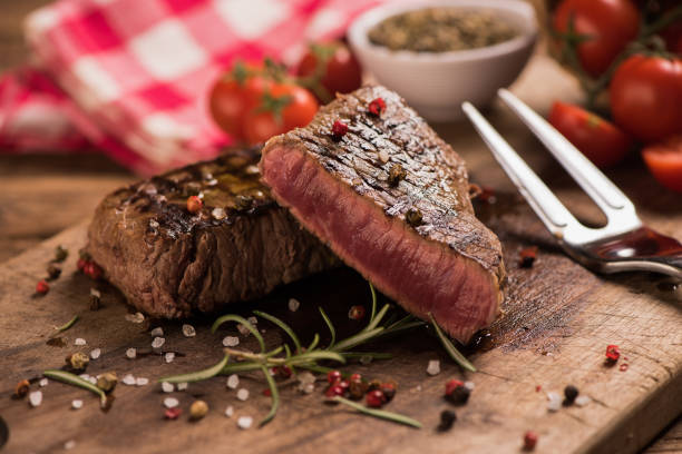 istock Delicious beef steak on wooden table, close-up 920730398