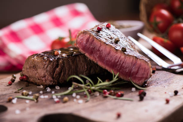 istock Delicious beef steak on wooden table, close-up 920730436