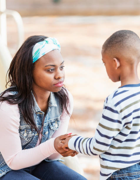 istock Mother talking to little boy on playground 920733156