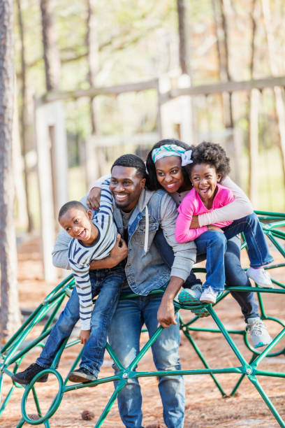 african-american family with two children on playground - child jungle gym playground laughing imagens e fotografias de stock