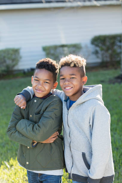 istock Confident mixed race boys, brothers standing together 920733354