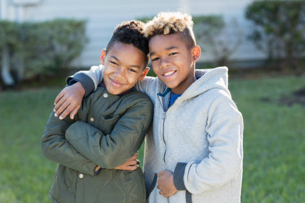 istock Confident mixed race boys, brothers standing together 920733370