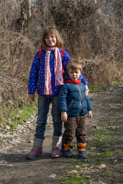 istock Brother and sister pose in nature 920733396