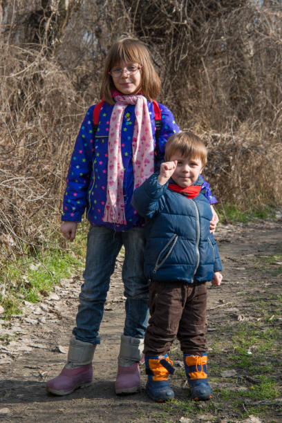 istock Brother and sister pose in nature 920735512