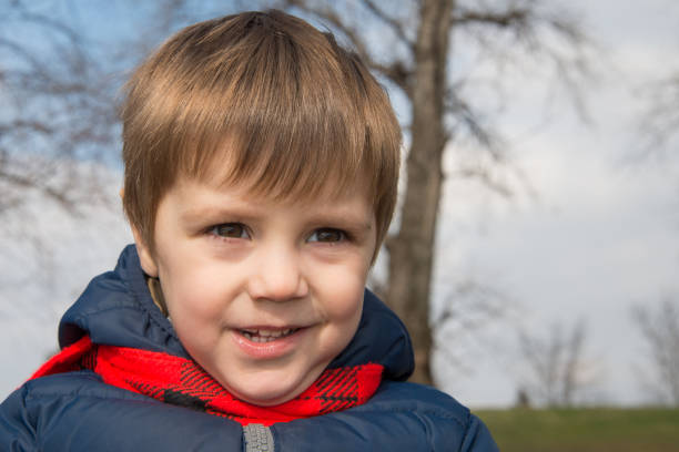 istock A boy with a red scarf poses in nature 920735910
