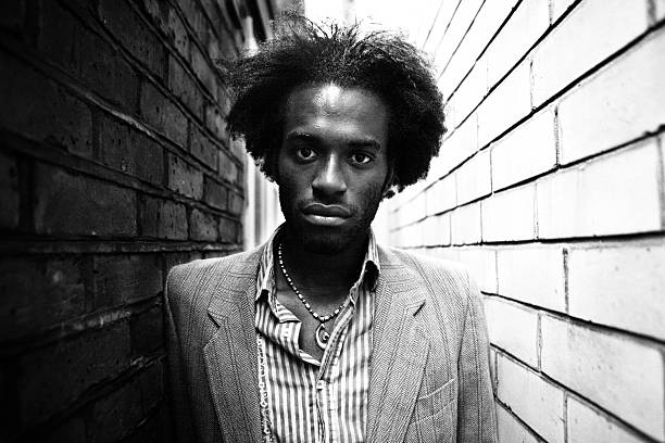 istock Young Man with Wild Hair Between Brick Walls 92073616