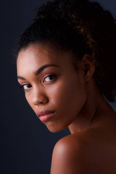 istock Close up beautiful black woman against dark background 920743286