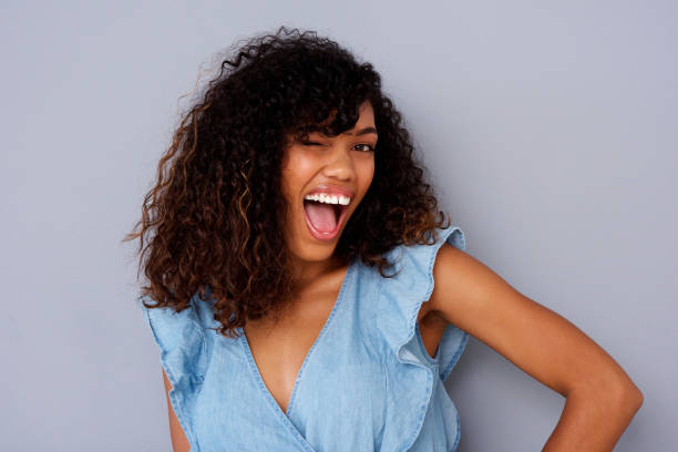 istock cheerful young black woman winking 920743312