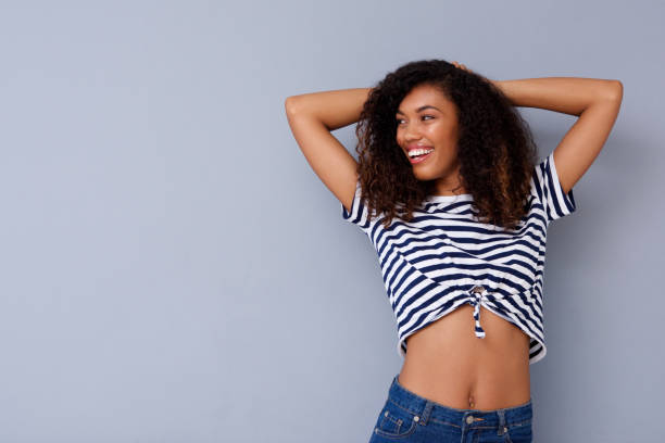 istock attractive african woman smiling with hands behind head 920743380