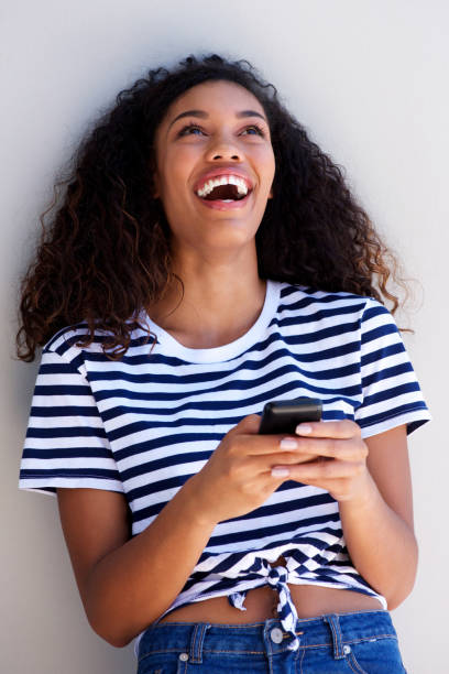 istock young woman laughing with cellphone 920743446